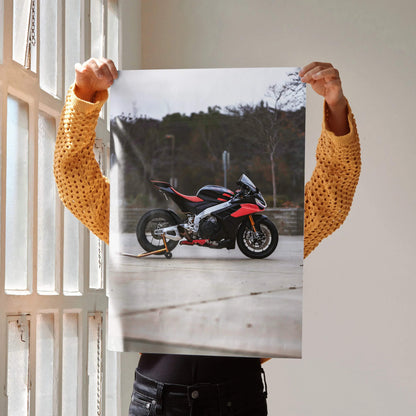 Poster wall art featuring a red and black Aprilia RSV4 1100 Factory motorcycle against an outdoor backdrop.