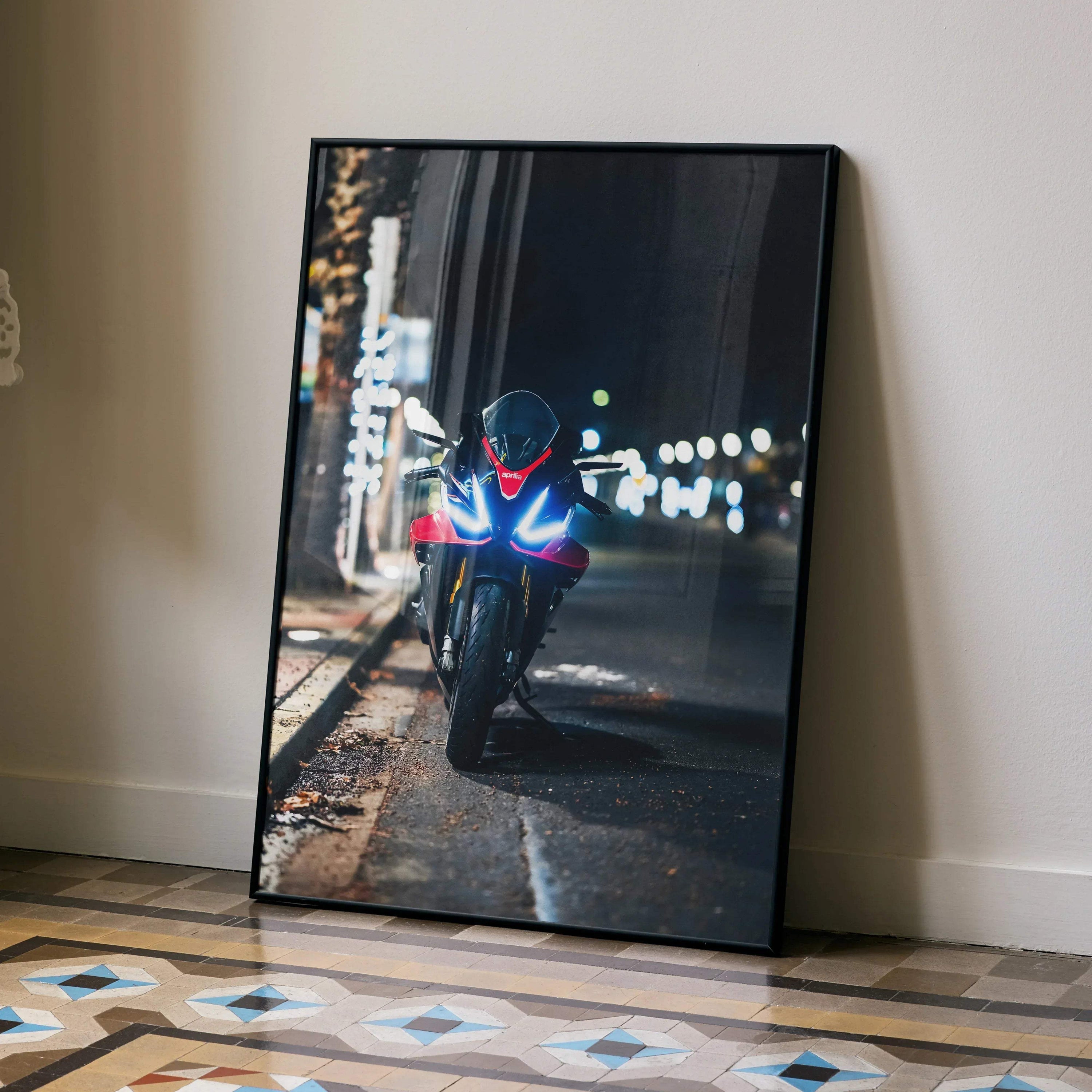 Aprilia RSV4 1100 Factory motorcycle with headlights on parked on city street at night poster wall art.