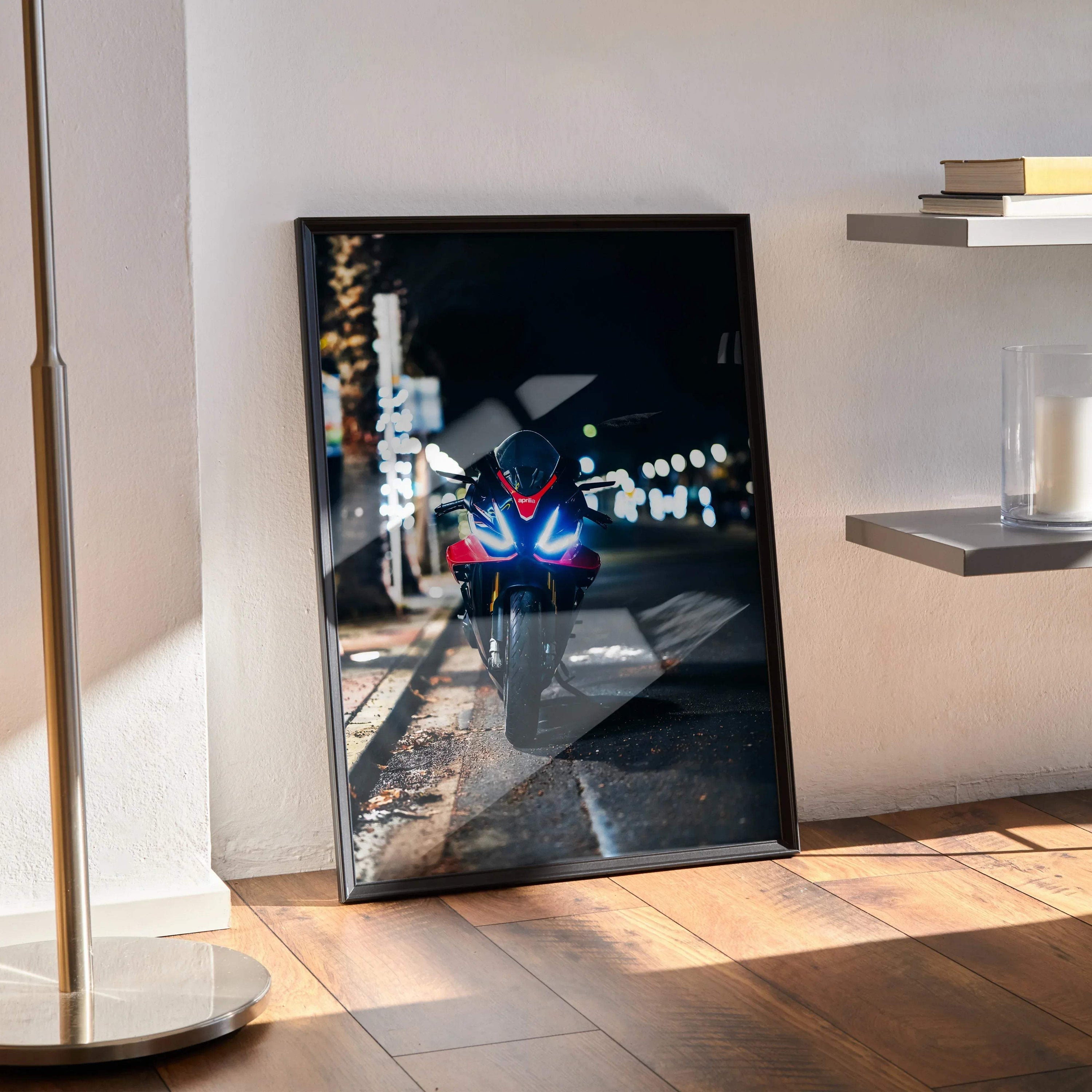 Aprilia RSV4 1100 Factory motorcycle night scene poster leaning on floor, modern wall art in black frame.
