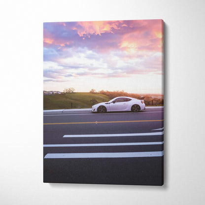 White Toyota FRS car on road at sunset canvas wall art with vibrant sky colors.