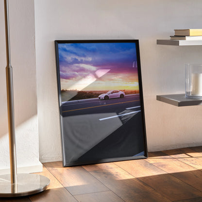Framed Toyota FRS car poster with sunset background leaning on wooden floor wall art.