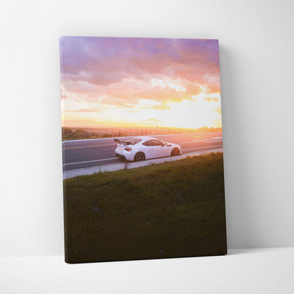 Toyota FRS white sports car at sunset on canvas wall art with purple and orange sky.