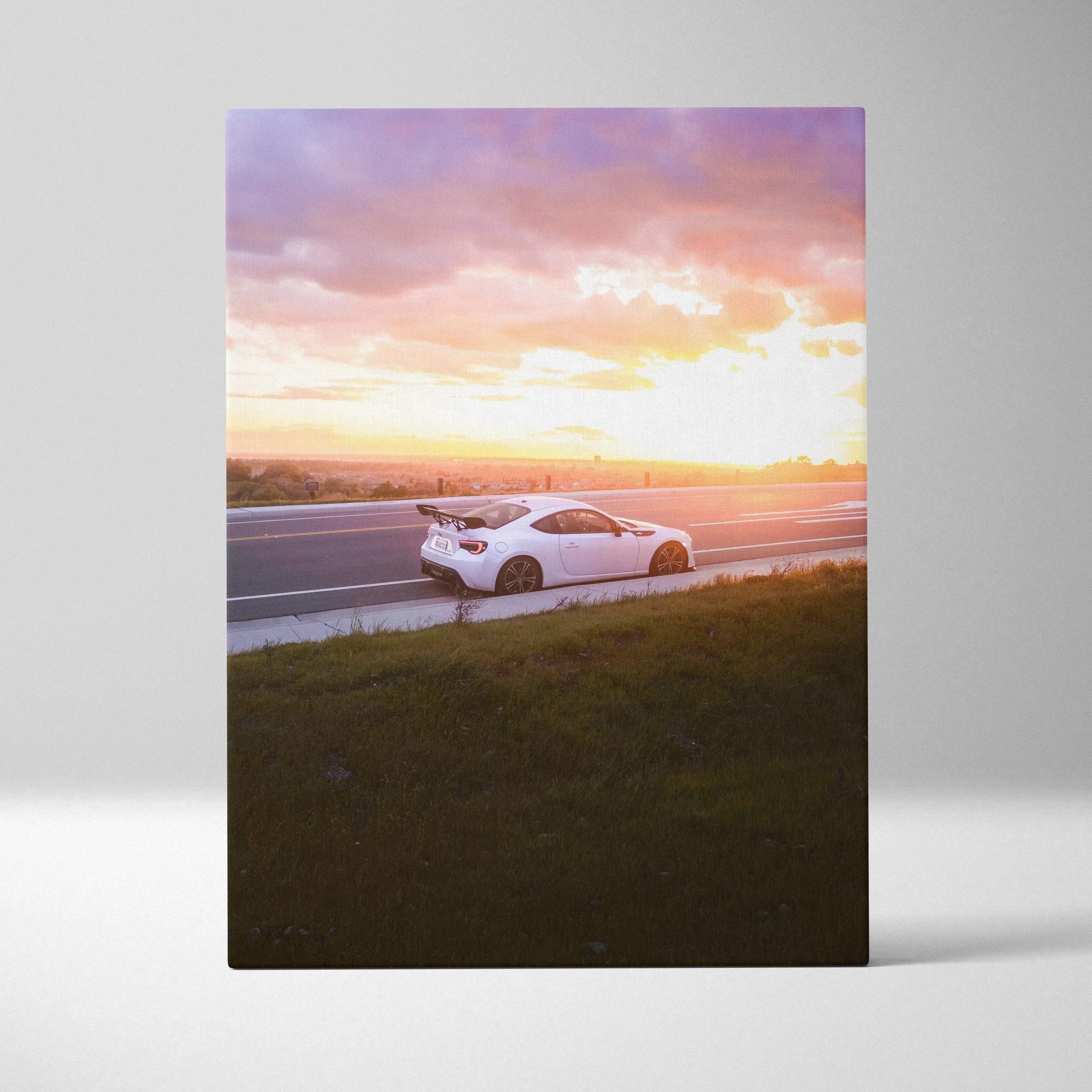White Toyota FRS on road at sunset with purple and orange sky canvas wall art.