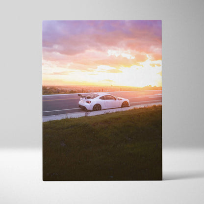 White Toyota FRS on road at sunset with purple and orange sky canvas wall art.