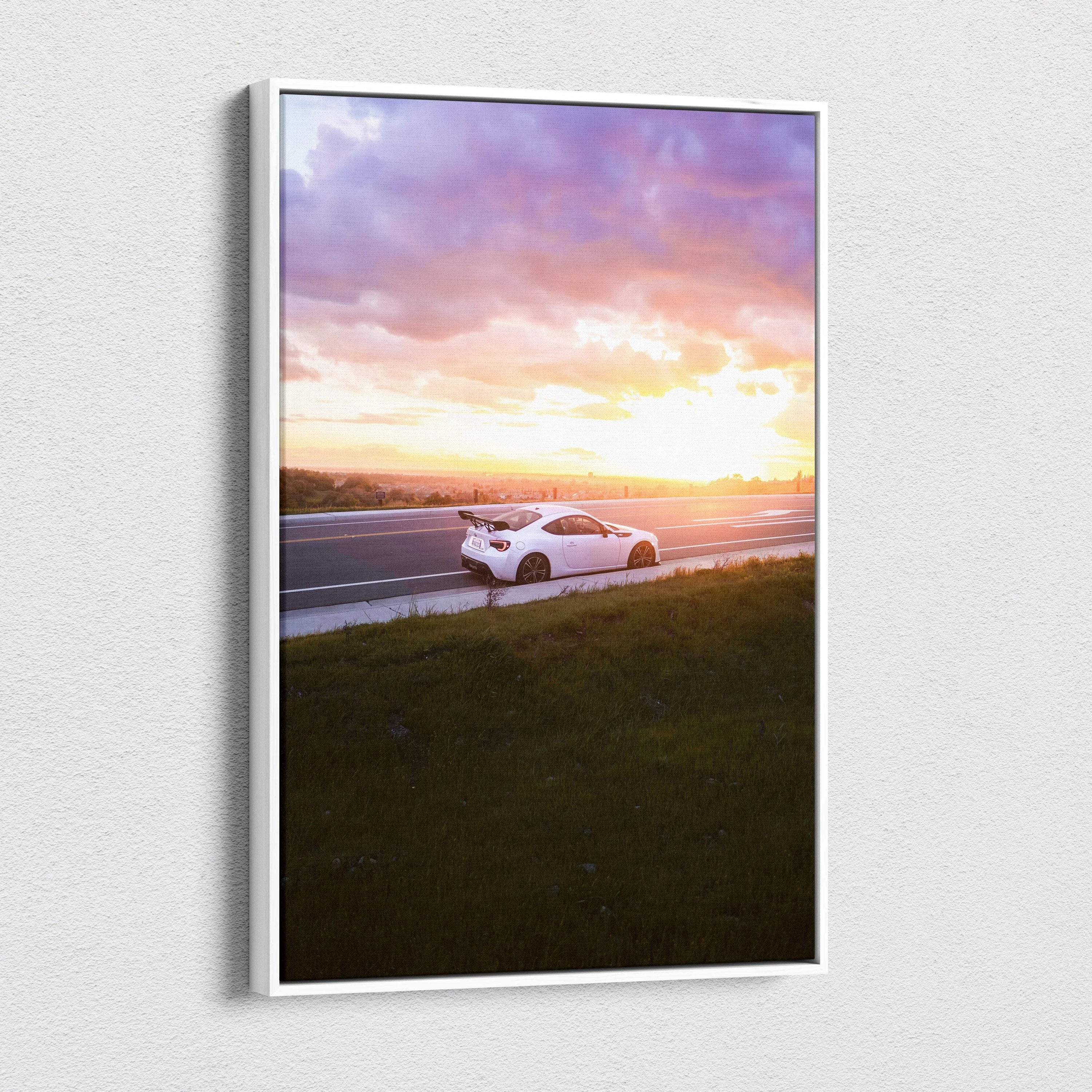 Vertical canvas wall art of a white Toyota FRS on a road at sunset with vibrant purple and orange sky.
