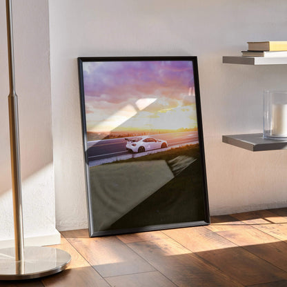 Toyota FRS car poster wall art with sunset background in black frame leaning on floor.