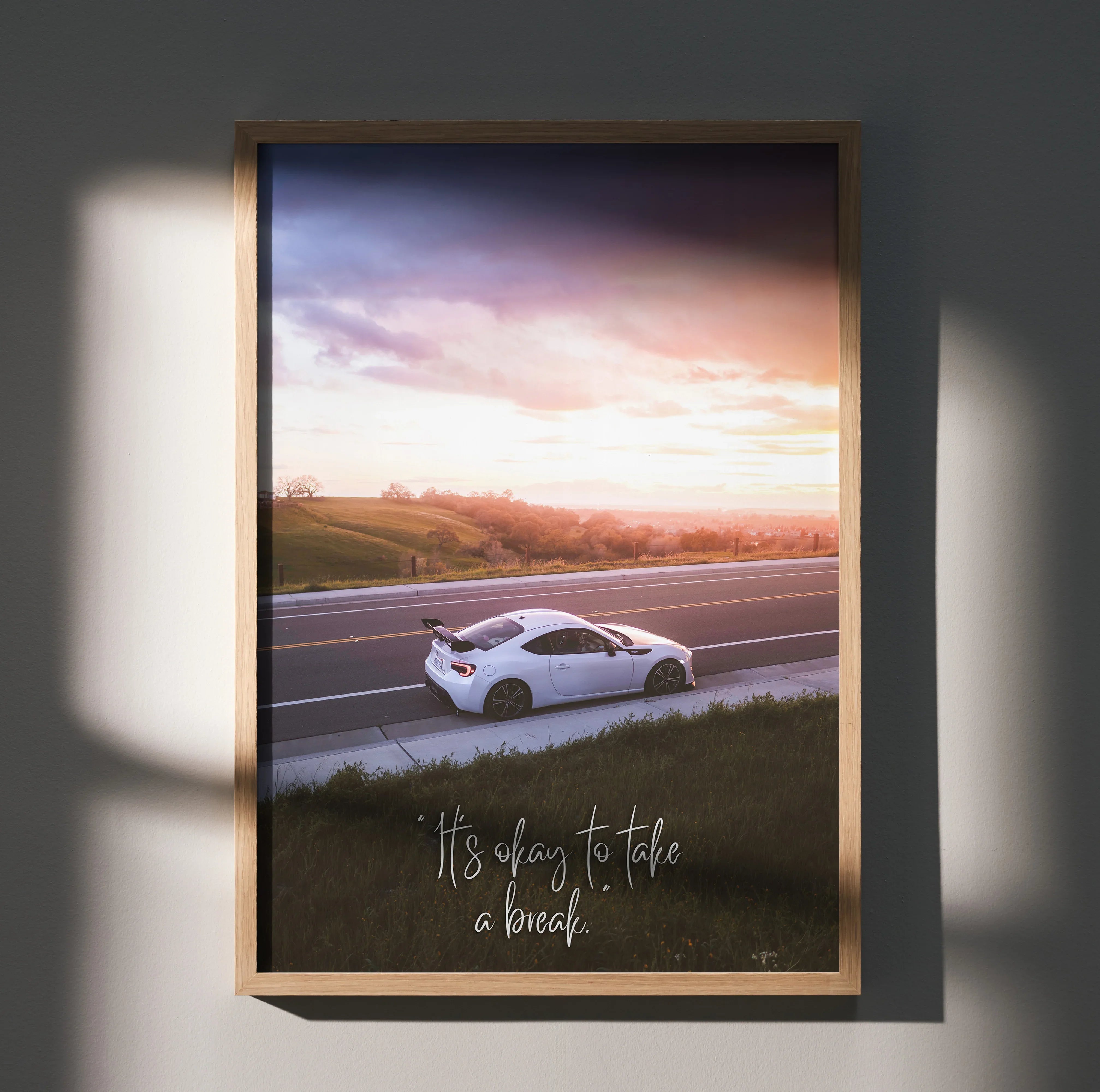 Motivational poster featuring white Toyota FRS on road at sunset with inspiring text, wall art decor.