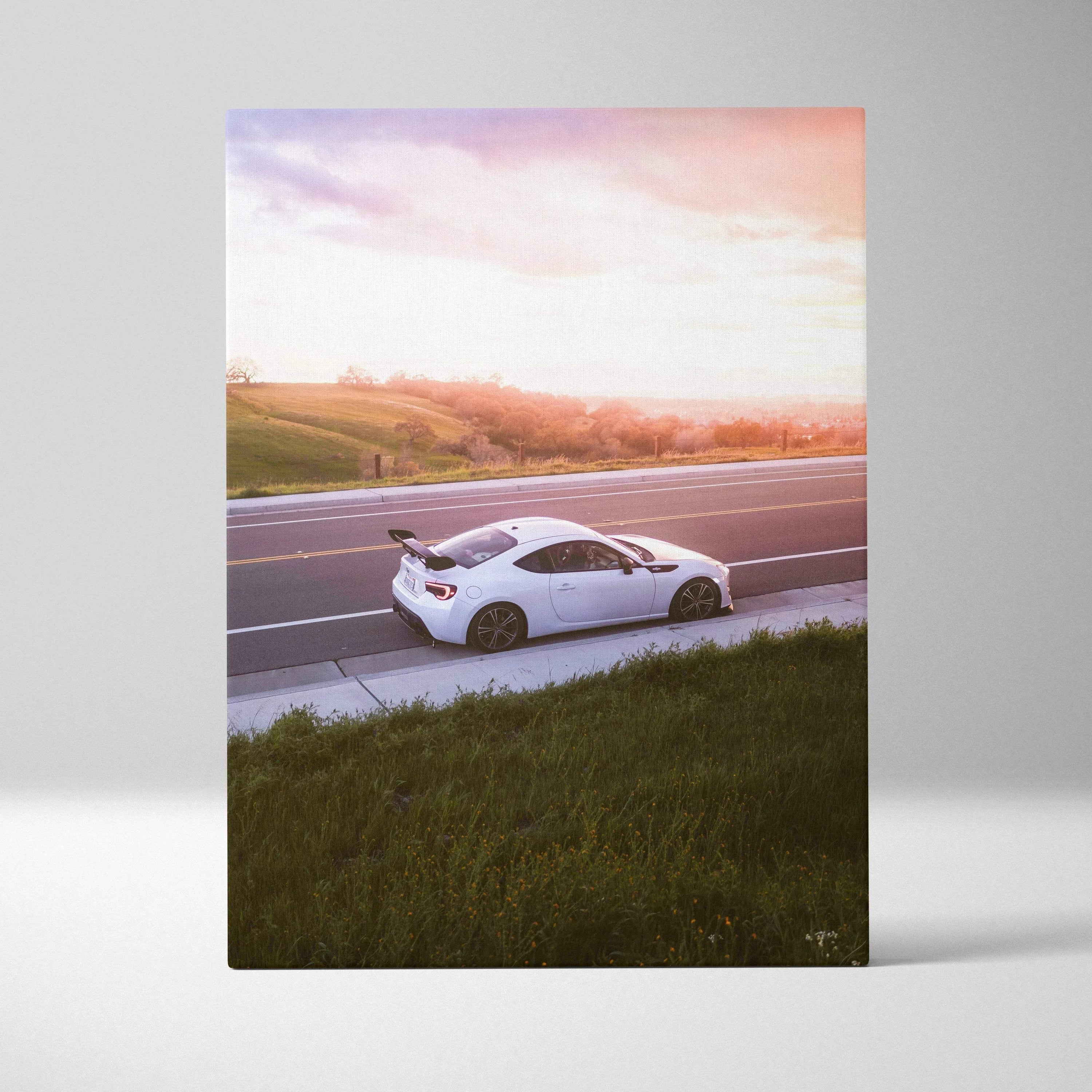 Toyota FRS sports car at sunset printed on vertical canvas wall art with warm sky tones.