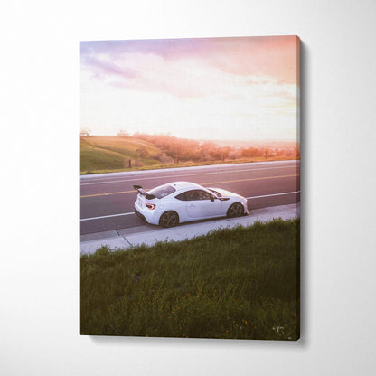 Toyota FRS white sports car driving on road at sunset wall art canvas print vertical.