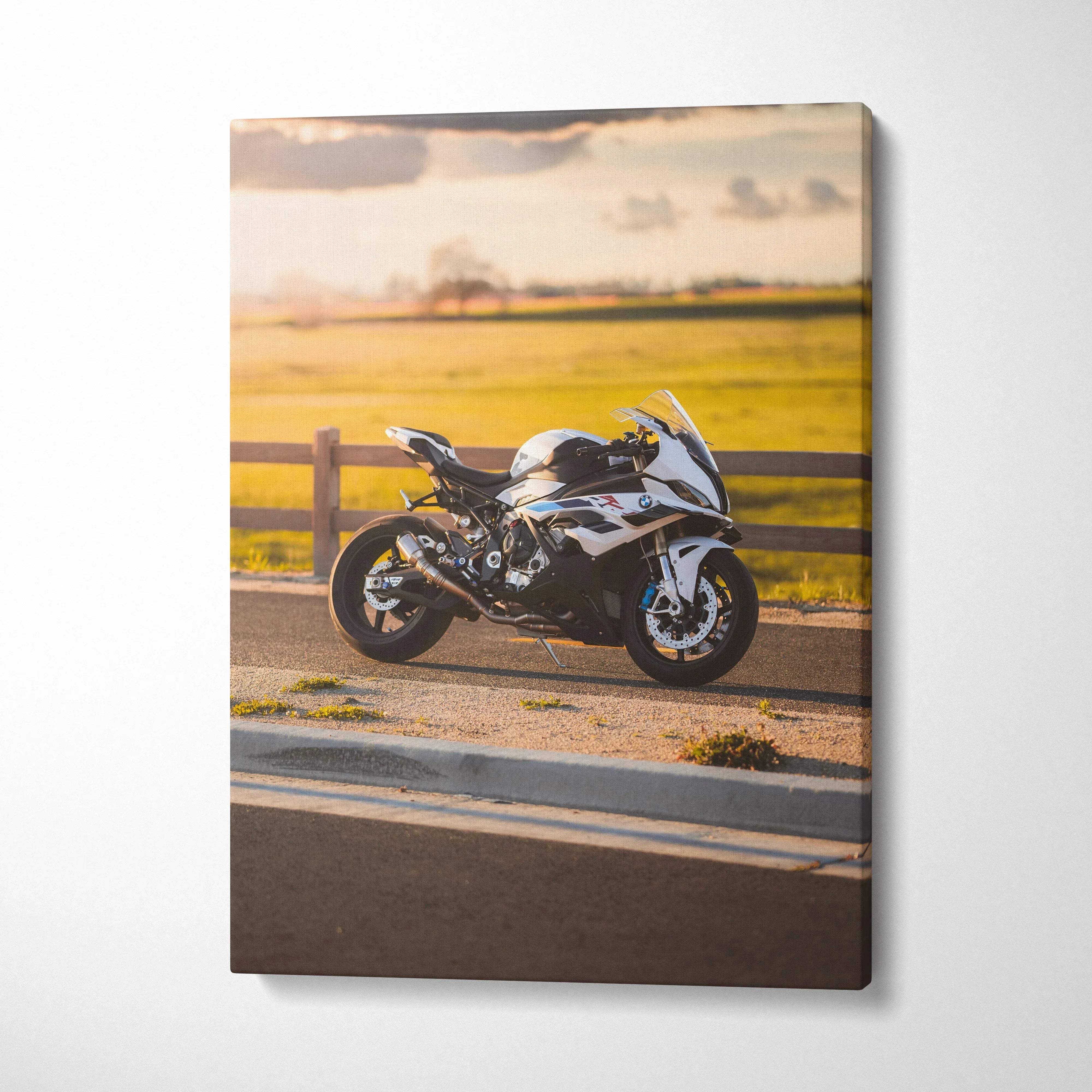 Vertical canvas wall art featuring a BMW S1000RR motorcycle on a scenic road at sunset.