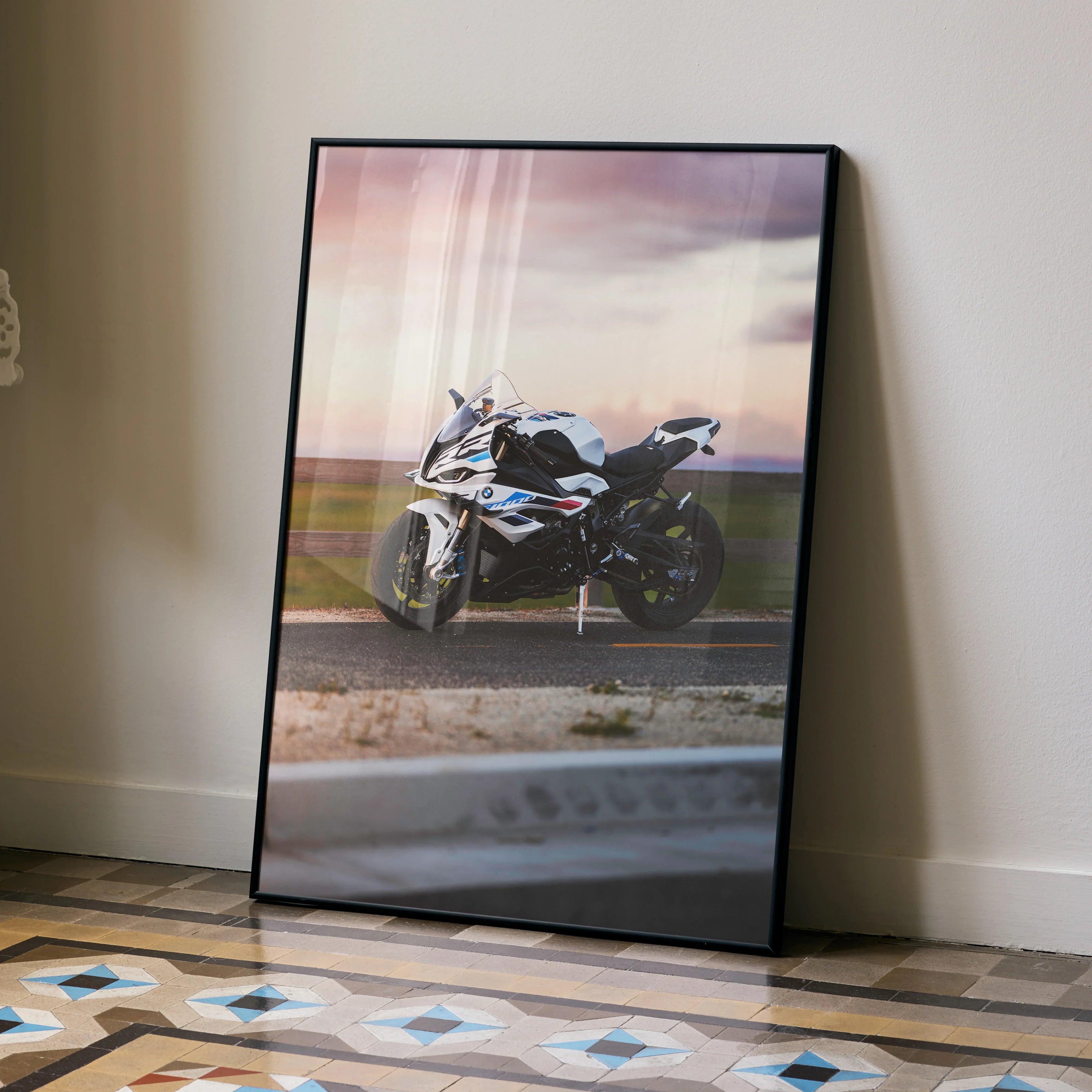 BMW S1000RR motorcycle poster with sunset background leaning against wall, modern wall art.