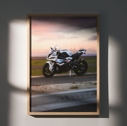 BMW S1000RR motorcycle poster wall art at sunset with sleek white bike and dynamic sky.