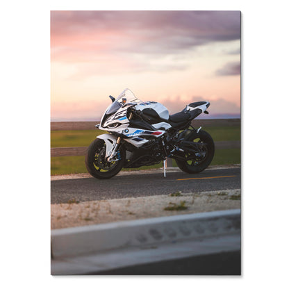 BMW S1000RR motorcycle parked on racetrack at sunset poster wall art with soft pink sky.