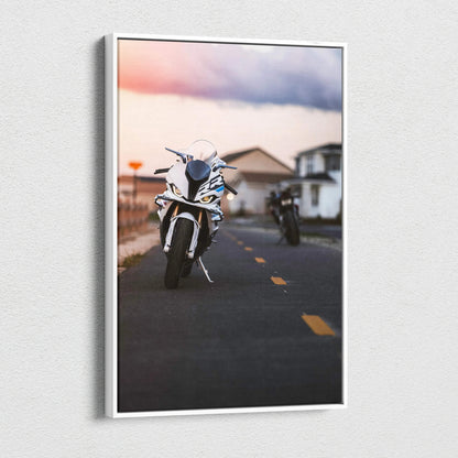 Vertical canvas wall art featuring a BMW S1000RR motorcycle on a road at sunset.