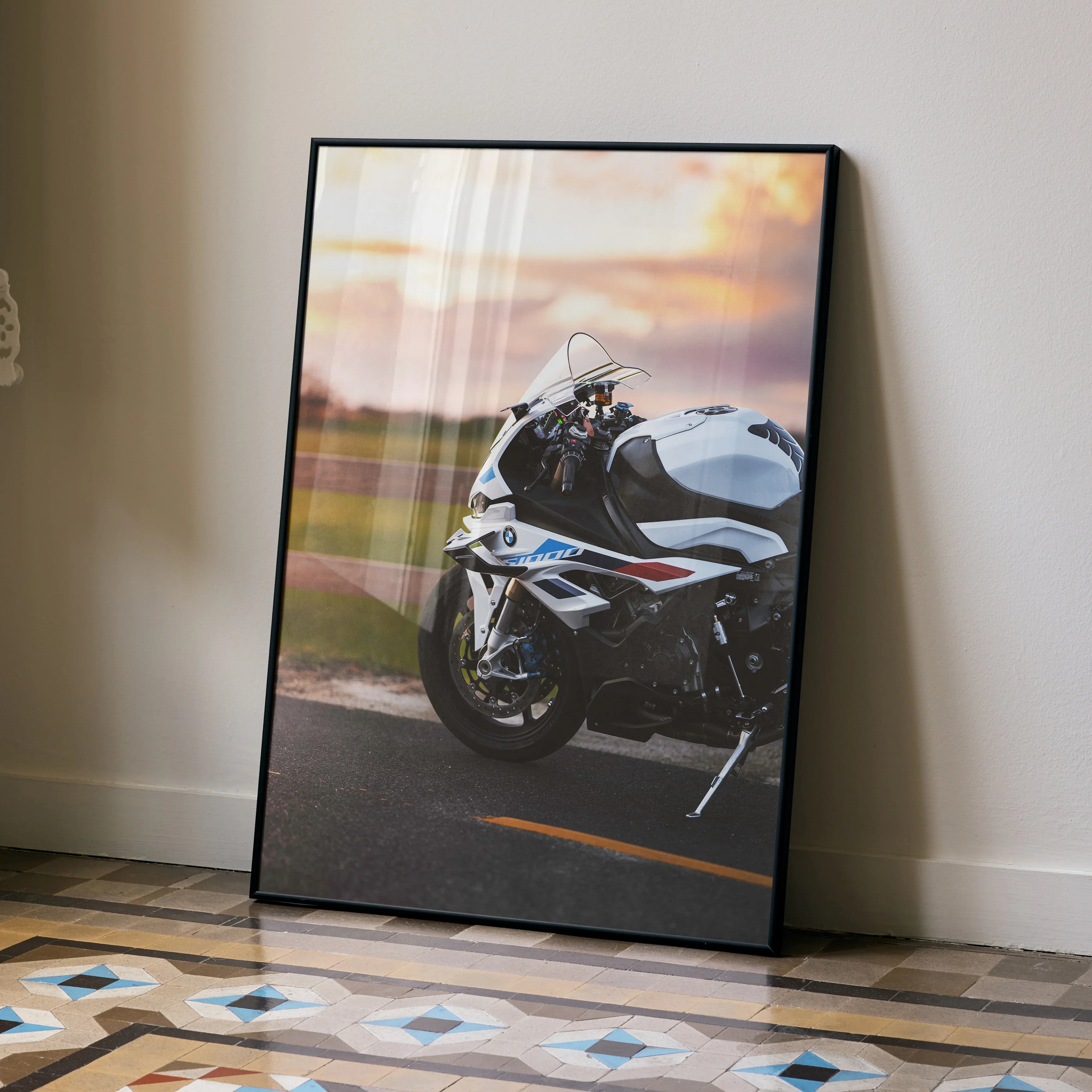 BMW S1000RR motorcycle wall art poster with sunset road background in a black frame.