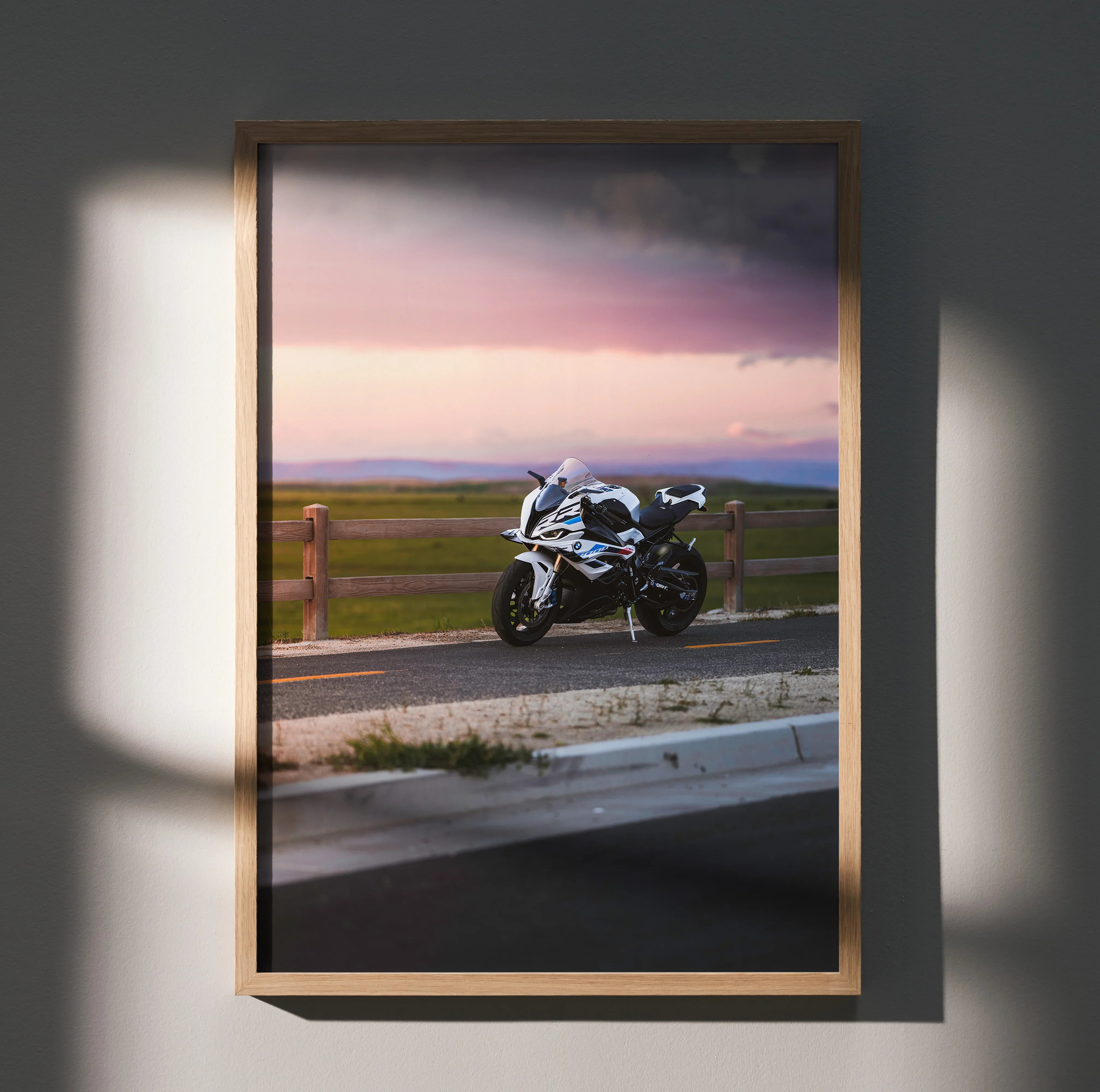 BMW S1000RR motorcycle poster wall art with sunset and rural road background in wooden frame.