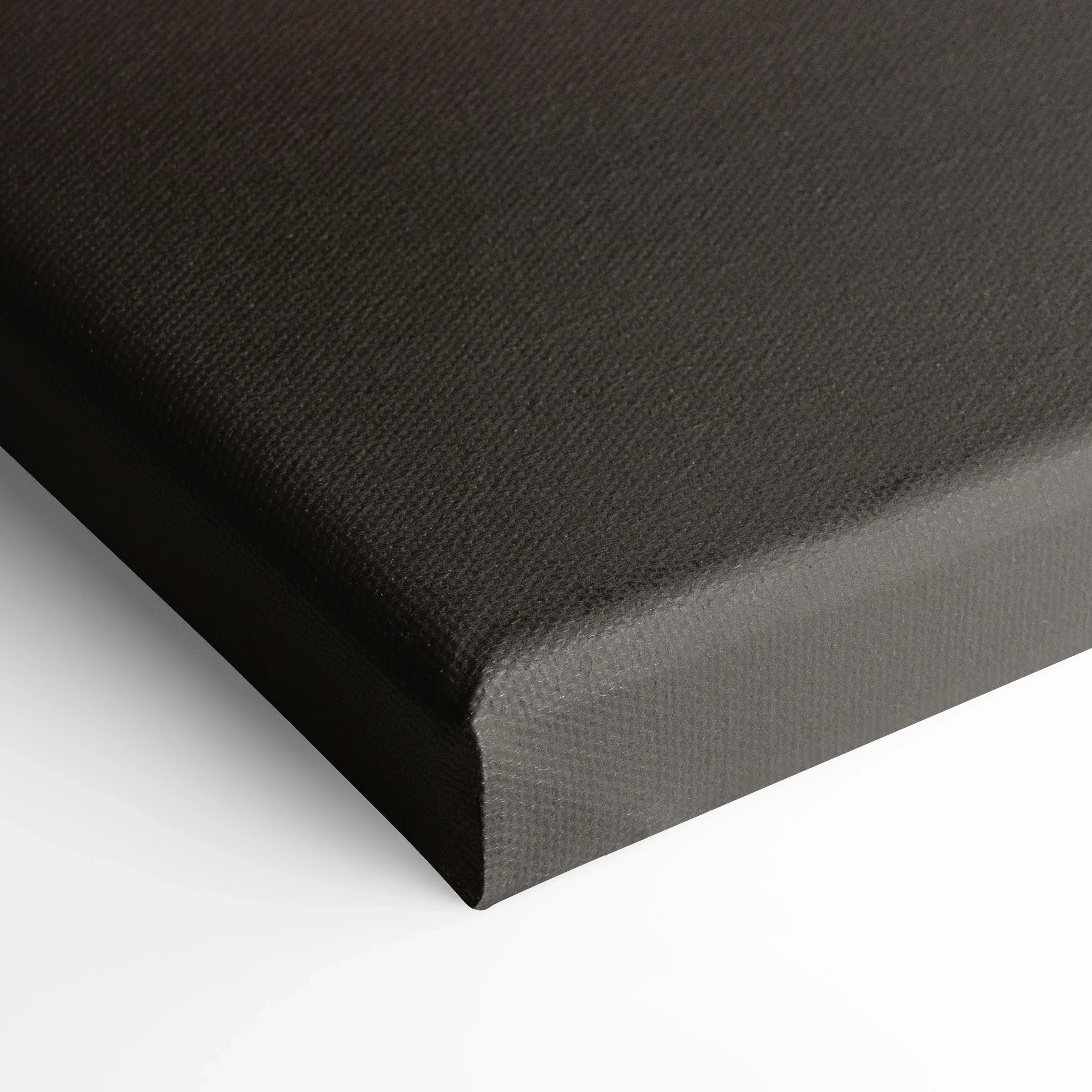 Black stretched canvas corner with textured fabric for wall art display.