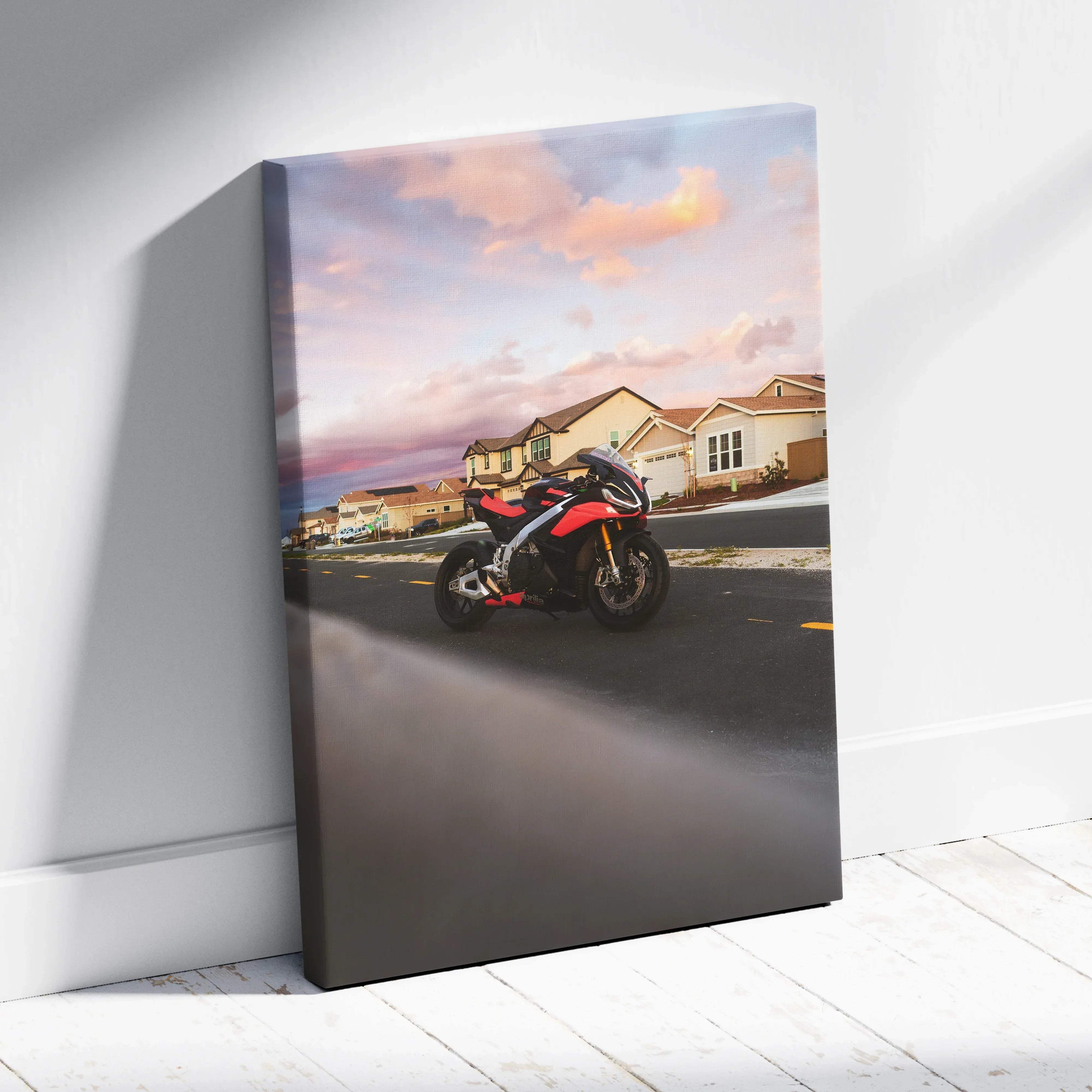 Canvas wall art of red and black aprilia rsv4 1100 factory sport motorcycle leaning against a white wall