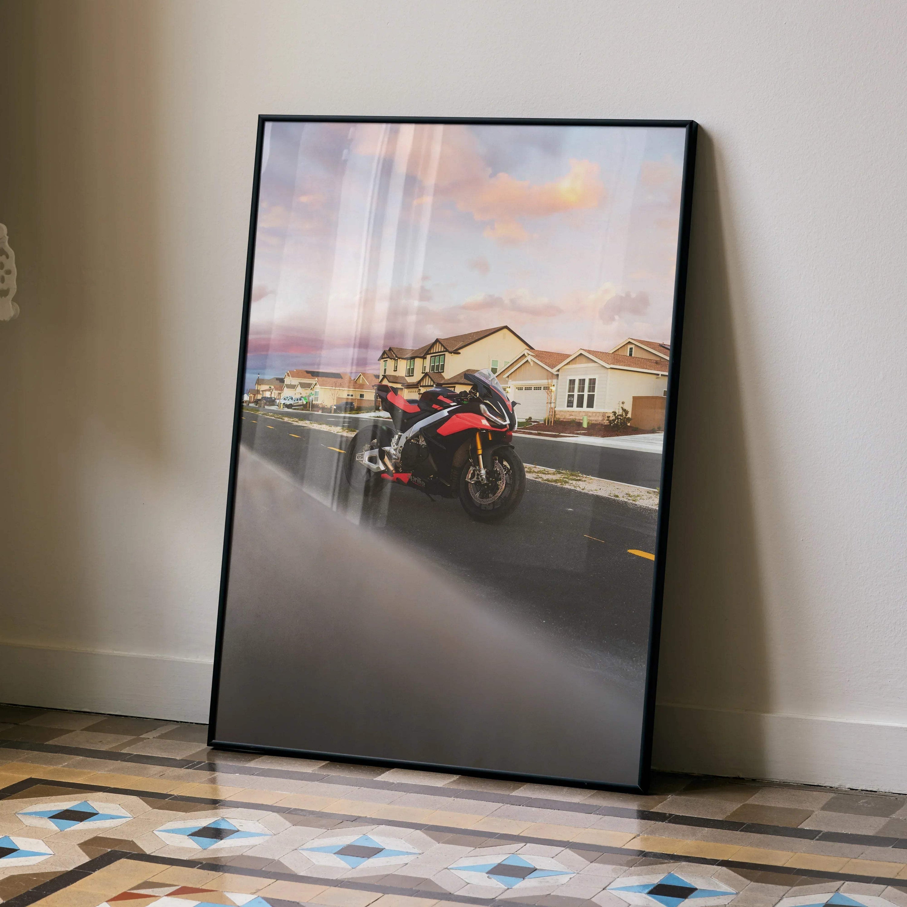 Aprilia RSV4 1100 Factory motorcycle poster with sunset background leaning against wall, wall art for decor.