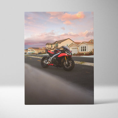 Vertical canvas wall art featuring an Aprilia RSV4 1100 Factory motorcycle at sunset on a suburban street.