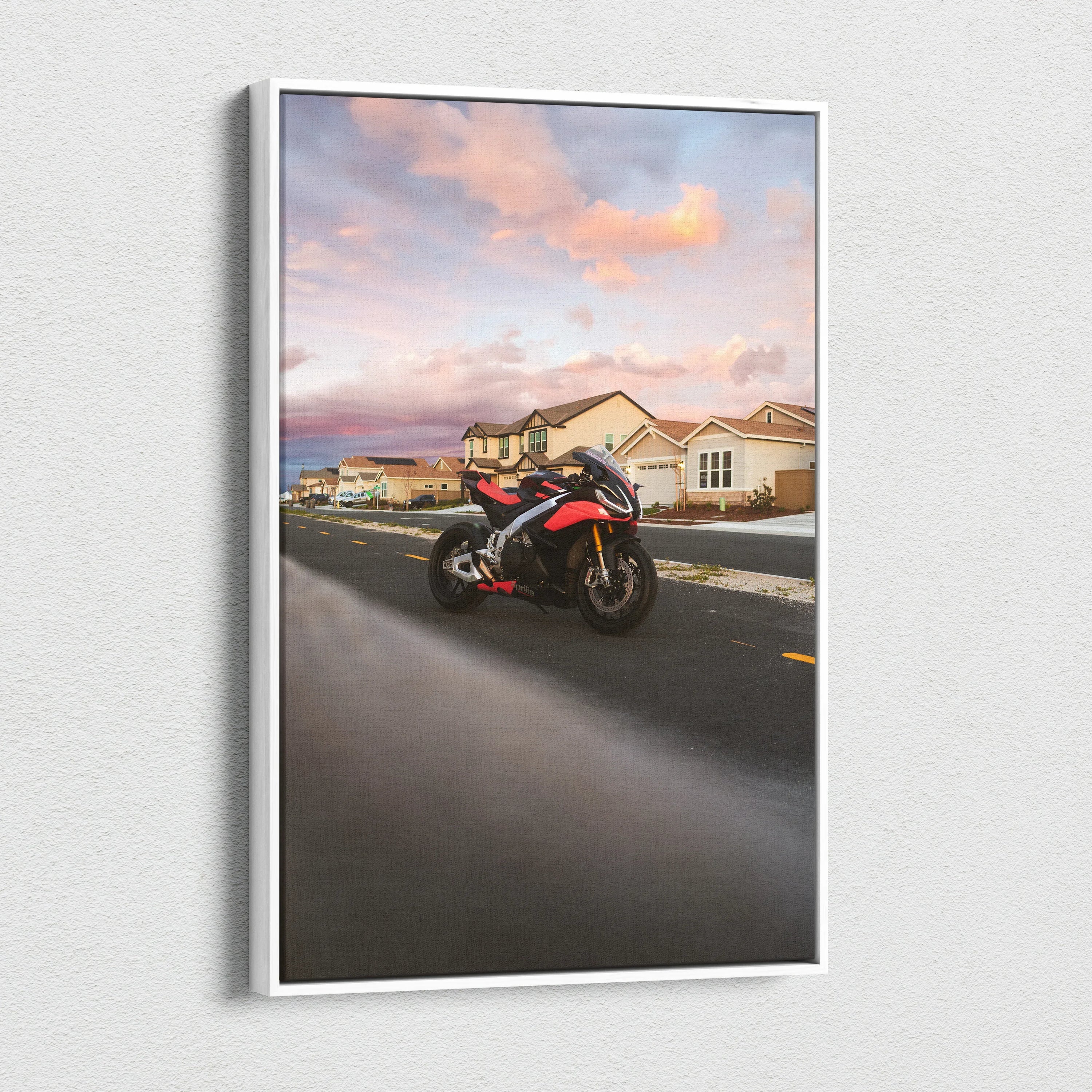 Aprilia RSV4 1100 motorcycle on road at sunset canvas wall art with vibrant sky and suburban houses.