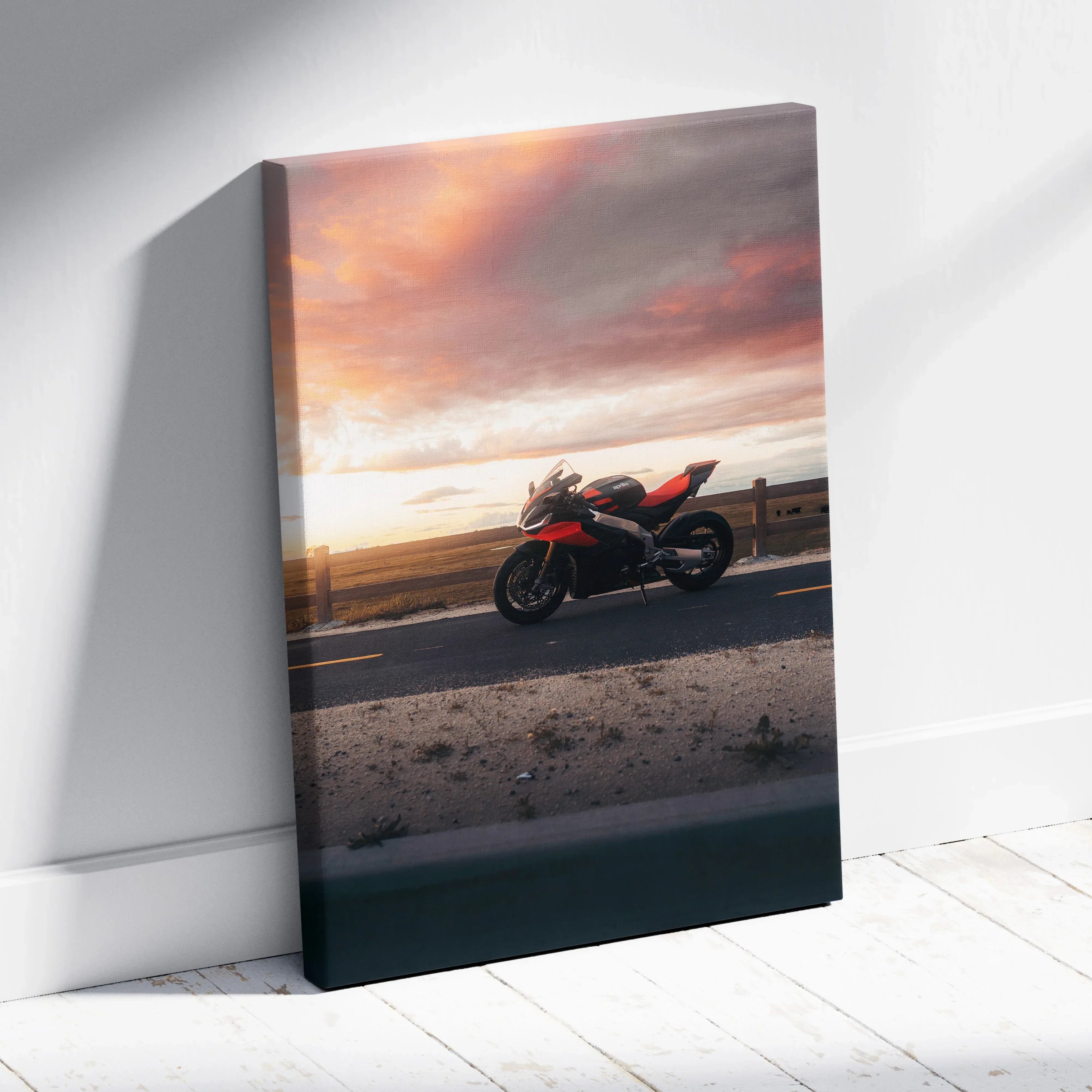 Aprilia RSV4 1100 Factory motorcycle at sunset on canvas wall art with vibrant sky colors.
