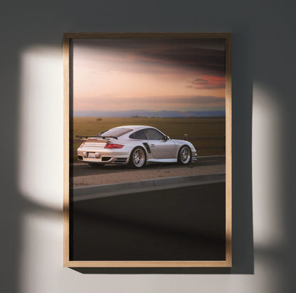 Porsche 911 Turbo driving at sunset poster wall art in wooden frame.