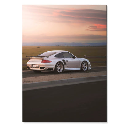 Porsche 911 Turbo poster with white sports car against sunset sky, automotive wall art.