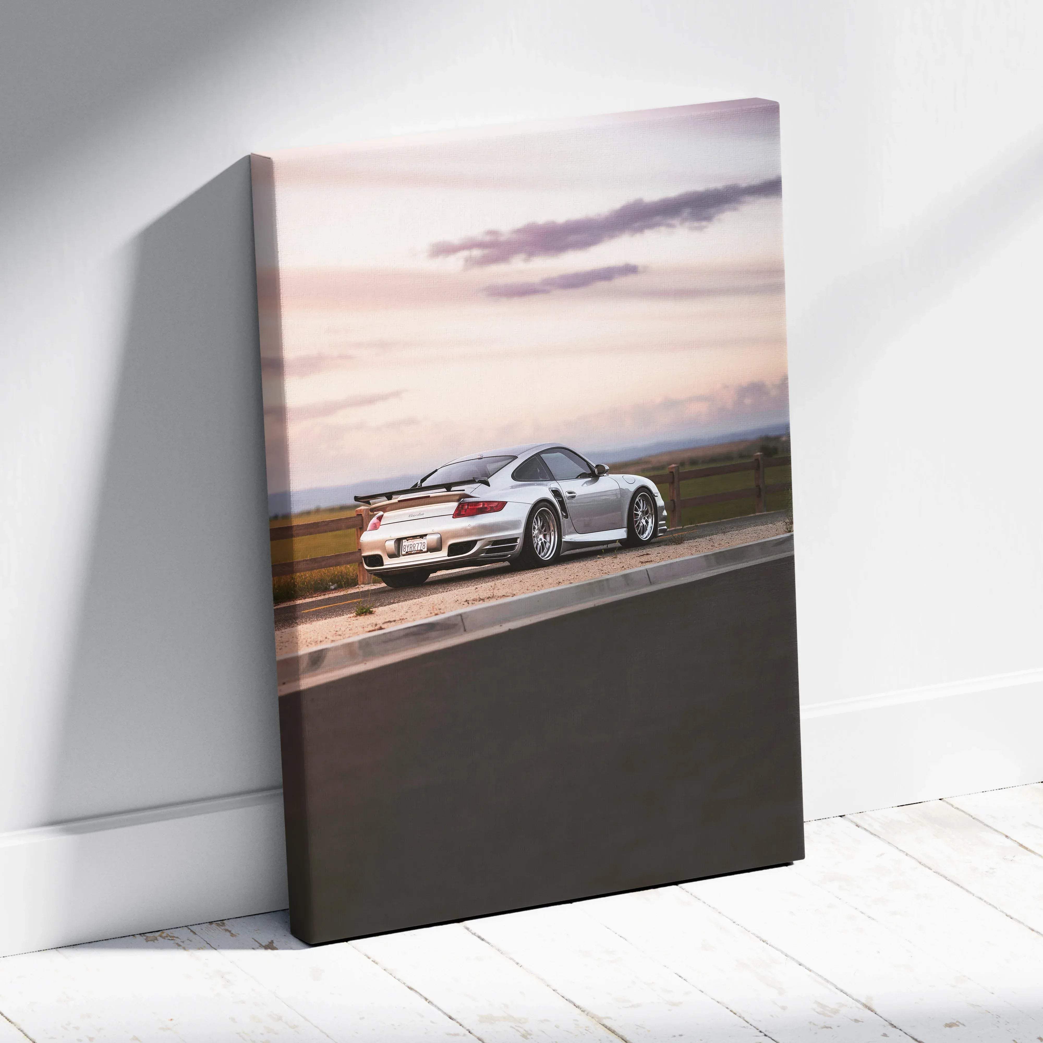 Silver porsche 911 turbo canvas wall art featuring sleek sports car in motion at sunset golden hour vertical print