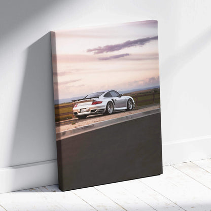 Porsche 911 Turbo in white driving on racetrack at sunset, high-resolution canvas wall art.