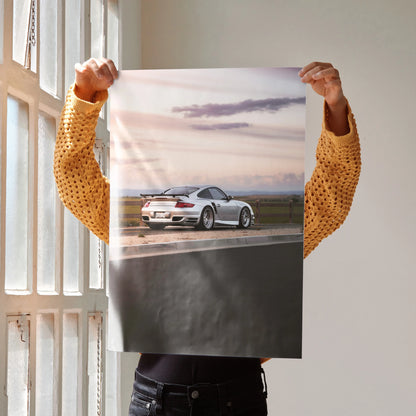 Porsche 911 Turbo Poster showing rear view of silver sports car on road at sunset, luxury wall art.