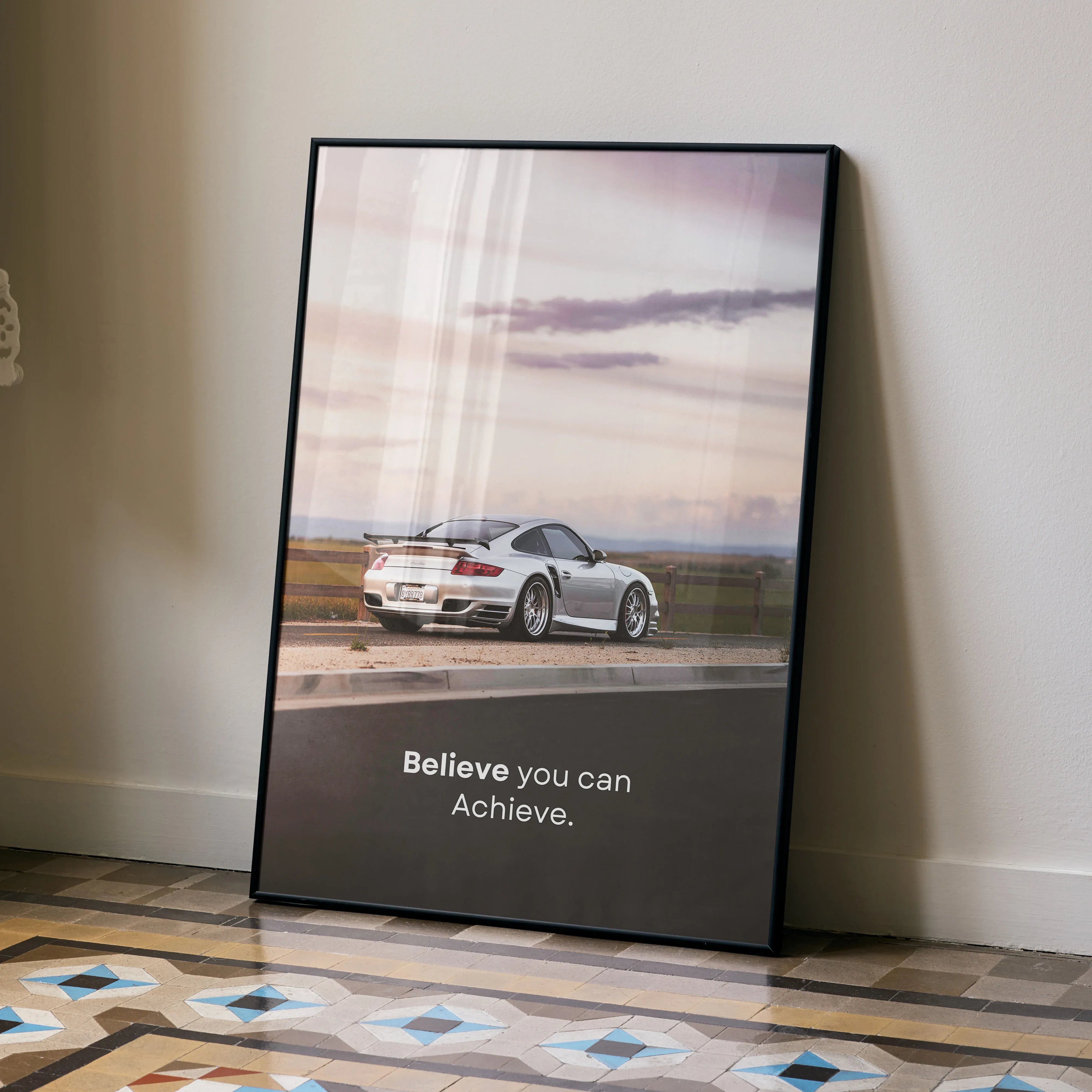 Porsche 911 Turbo on runway with motivational text wall art poster in black frame.