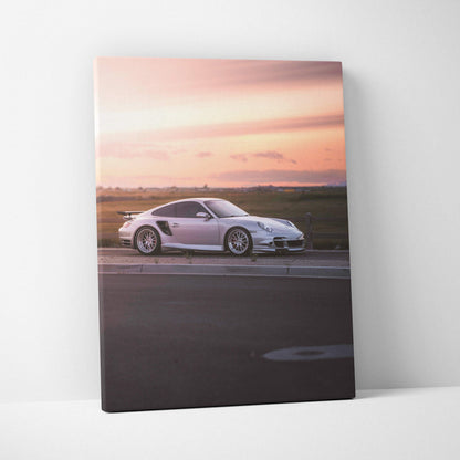 Porsche 911 Turbo on road at sunset canvas wall art with vibrant sky background.