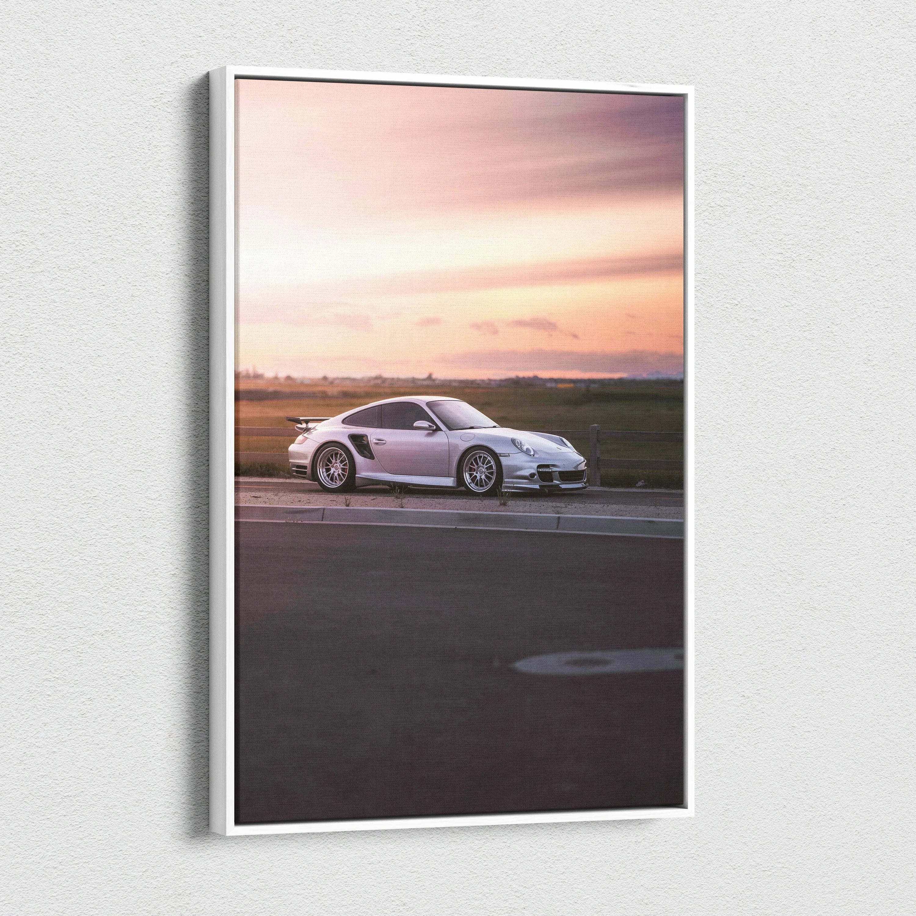 Vertical canvas wall art featuring a white Porsche 911 Turbo against a soft sunset sky.