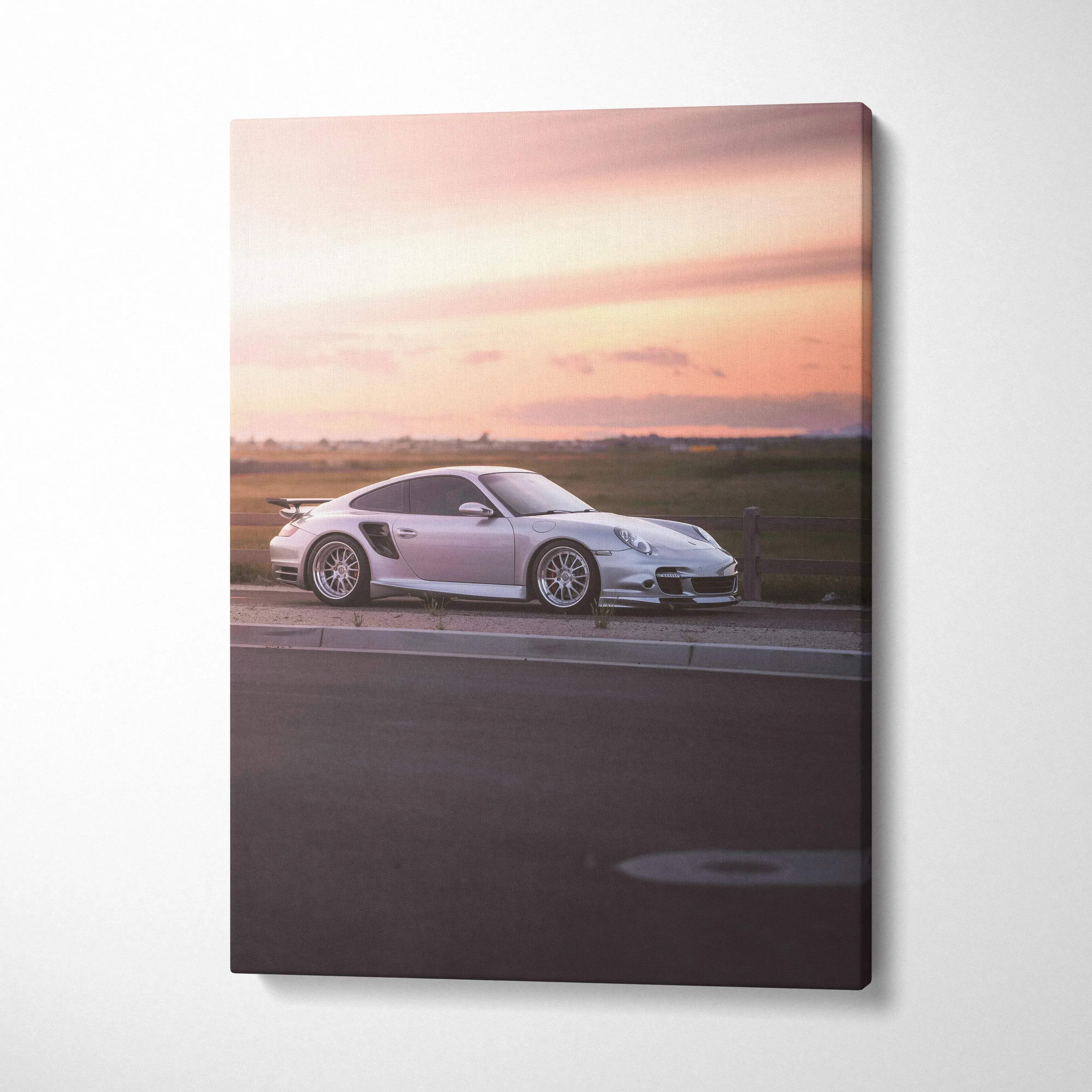 Porsche 911 Turbo against a glowing sunset sky on vertical canvas wall art.