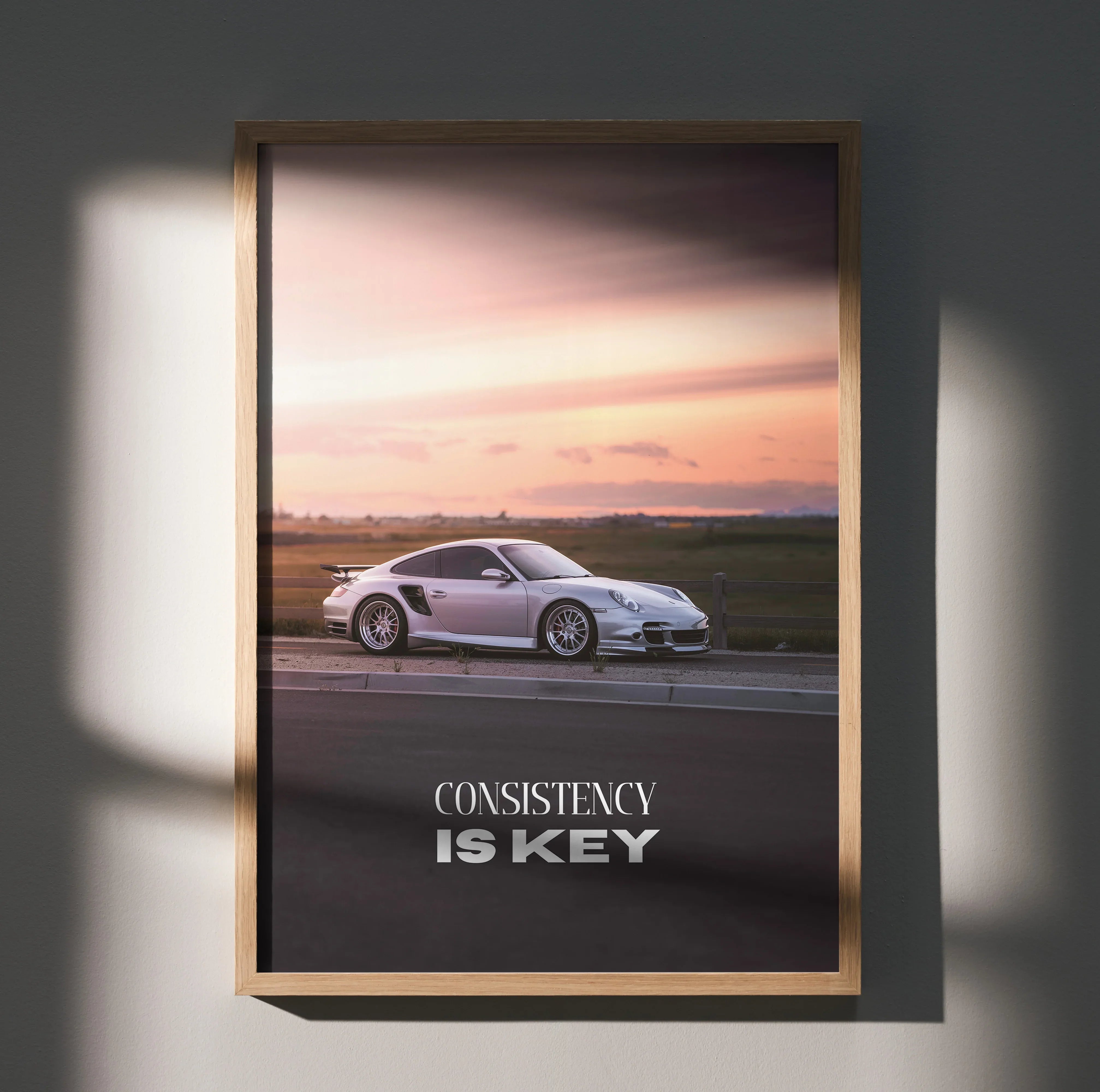 Porsche 911 Turbo driving at sunset with "Consistency is Key" motivational text poster wall art.