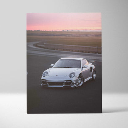 Porsche 911 Turbo sports car on racetrack with sunset sky canvas wall art.