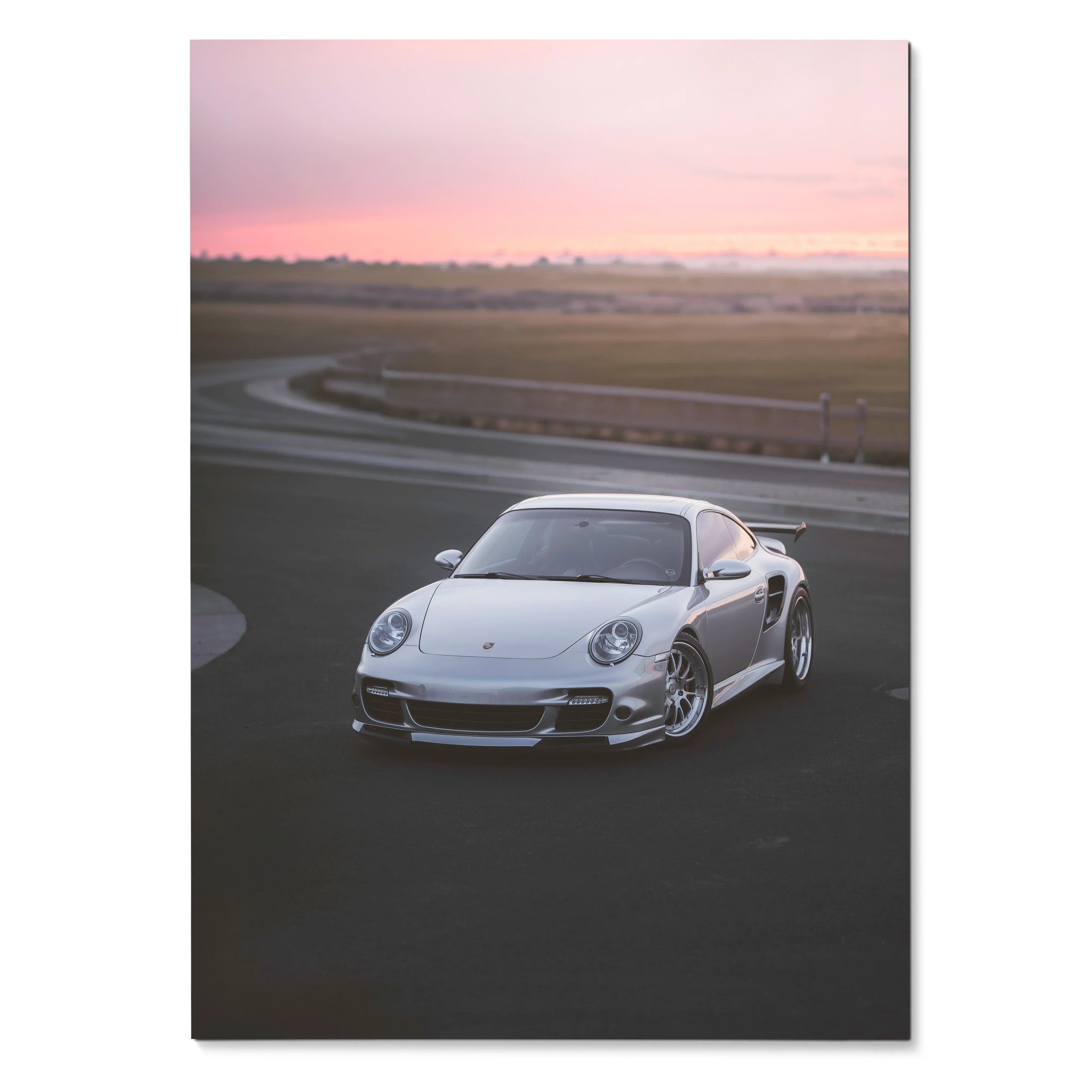 Porsche 911 Turbo on racetrack at sunset poster wall art with soft pink sky.