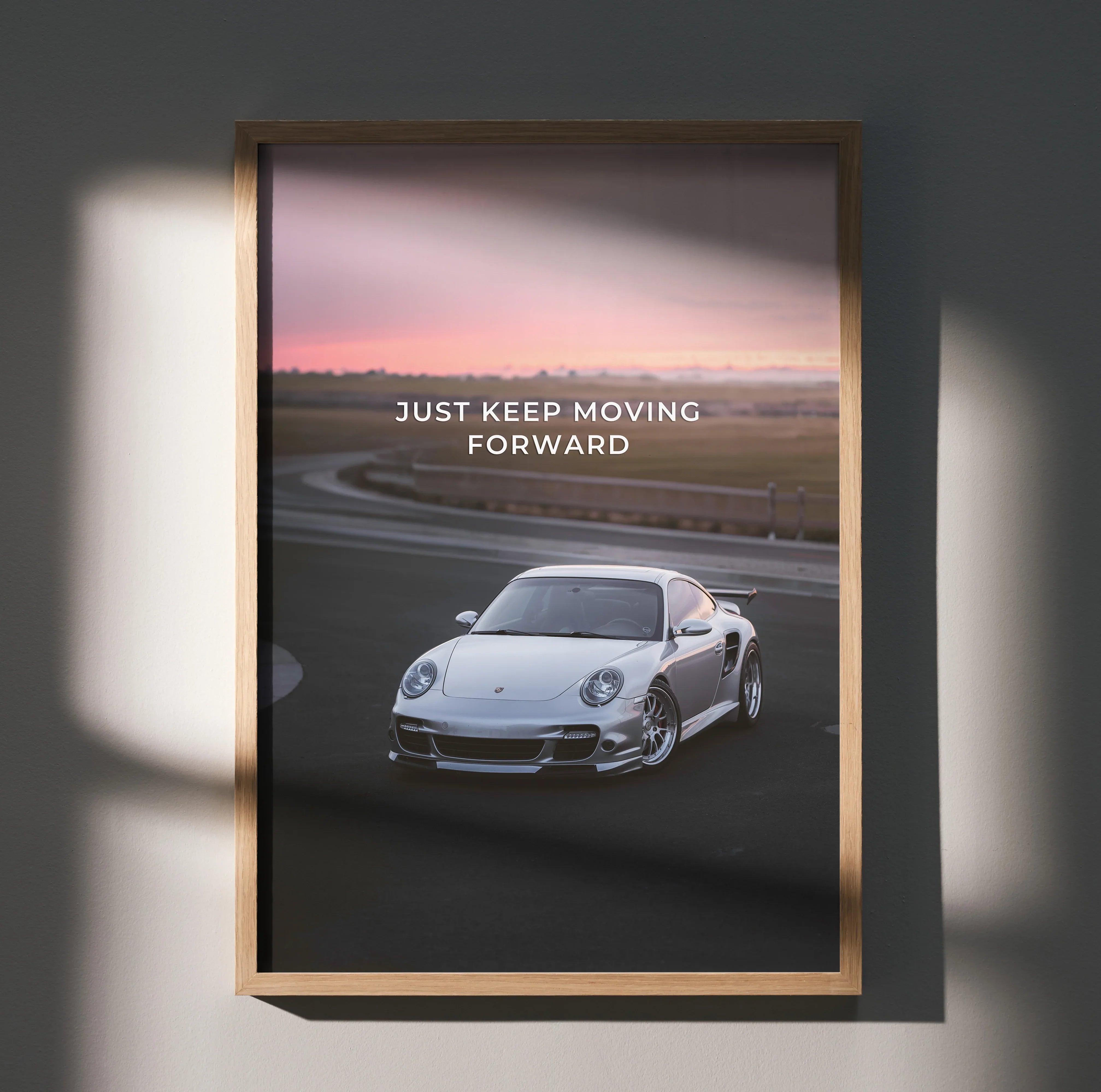 Motivational poster featuring white Porsche 911 Turbo on racetrack at sunset with "Just Keep Moving Forward" text wall art.