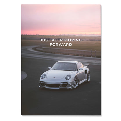 Poster featuring a silver Porsche 911 Turbo on a racetrack at sunset with "Just Keep Moving Forward" text wall art.