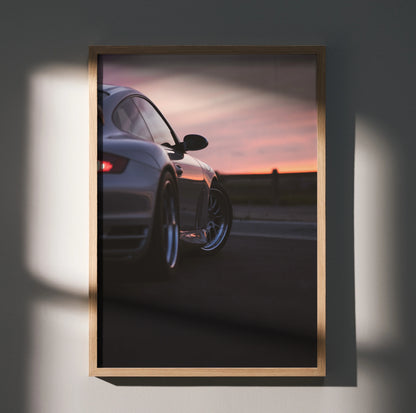 Porsche 911 Turbo wall art poster showing rear side of silver car at sunset with wooden frame.