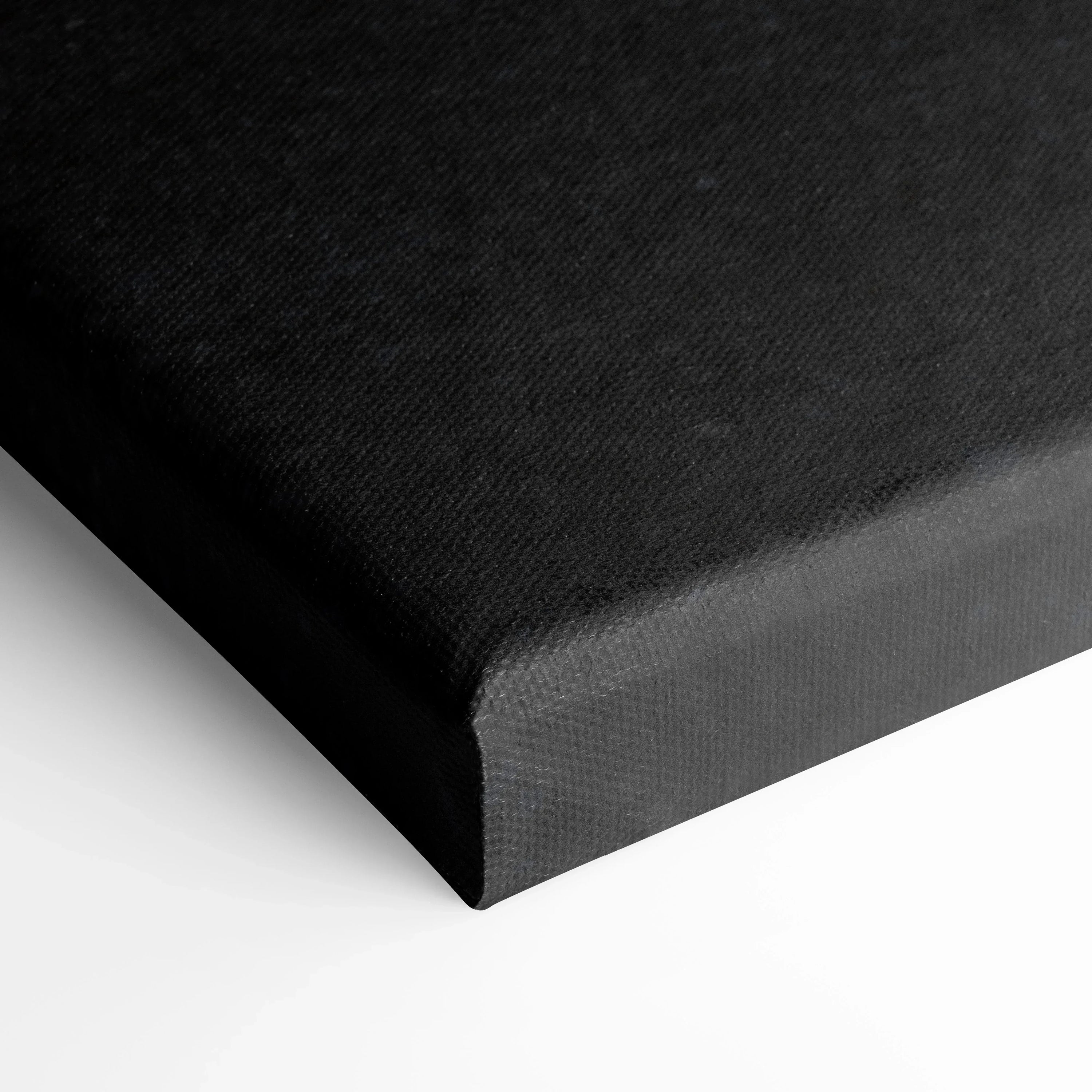 Close-up of black canvas edge with textured surface for high-resolution wall art.
