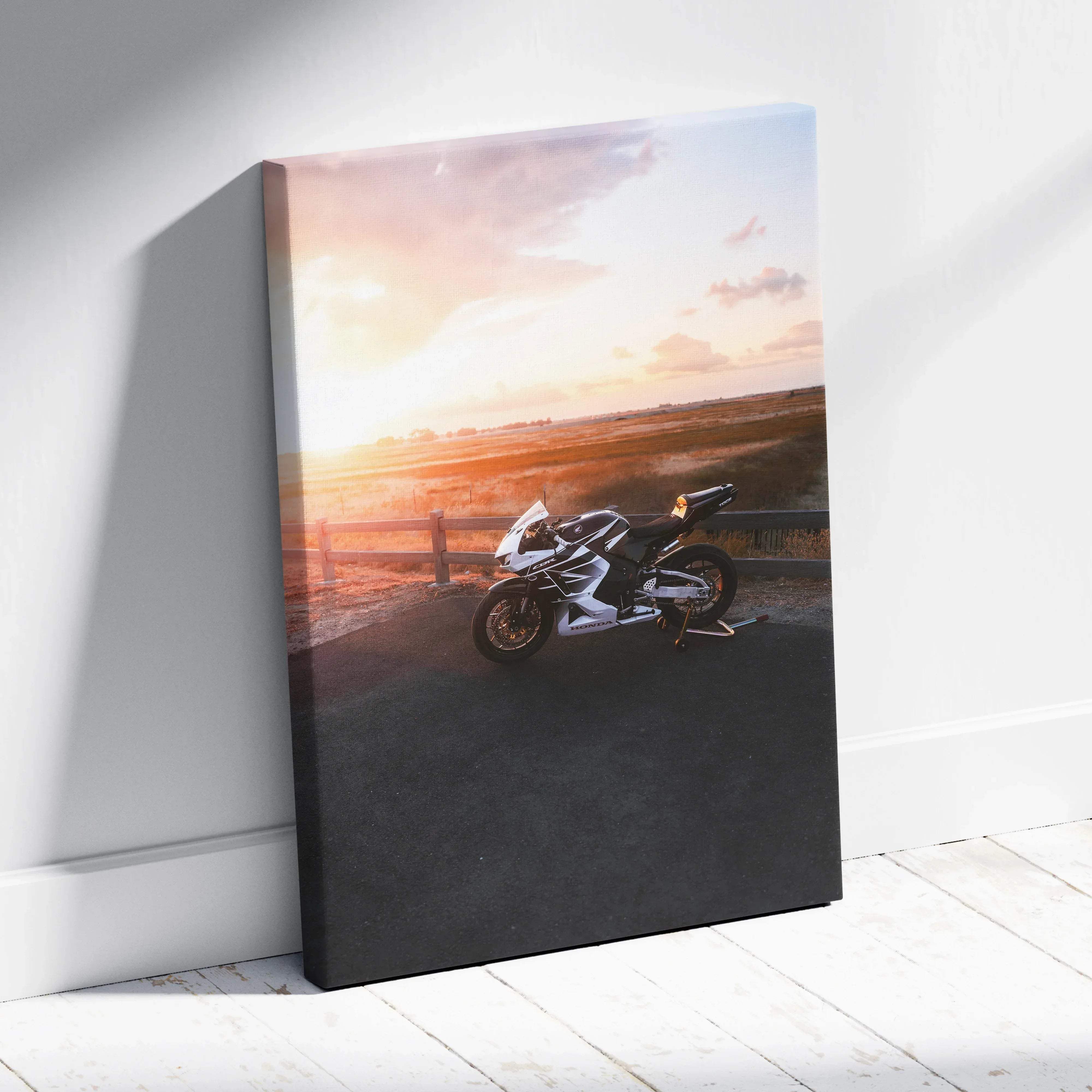 Canvas wall art featuring a white and black Honda CBR600RR sport motorcycle print with sunset glow in vertical format