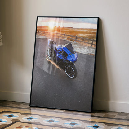 Yamaha R1 motorcycle poster with blue bike and sunset background wall art in black frame.