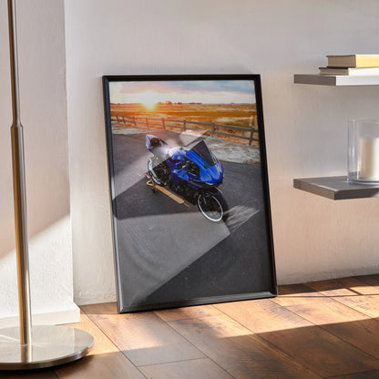 Yamaha R1 motorcycle poster with sunset background, framed wall art leaning on floor.