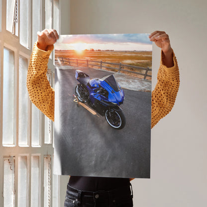 Poster wall art featuring a blue Yamaha R1 motorcycle parked by a beach at sunset.