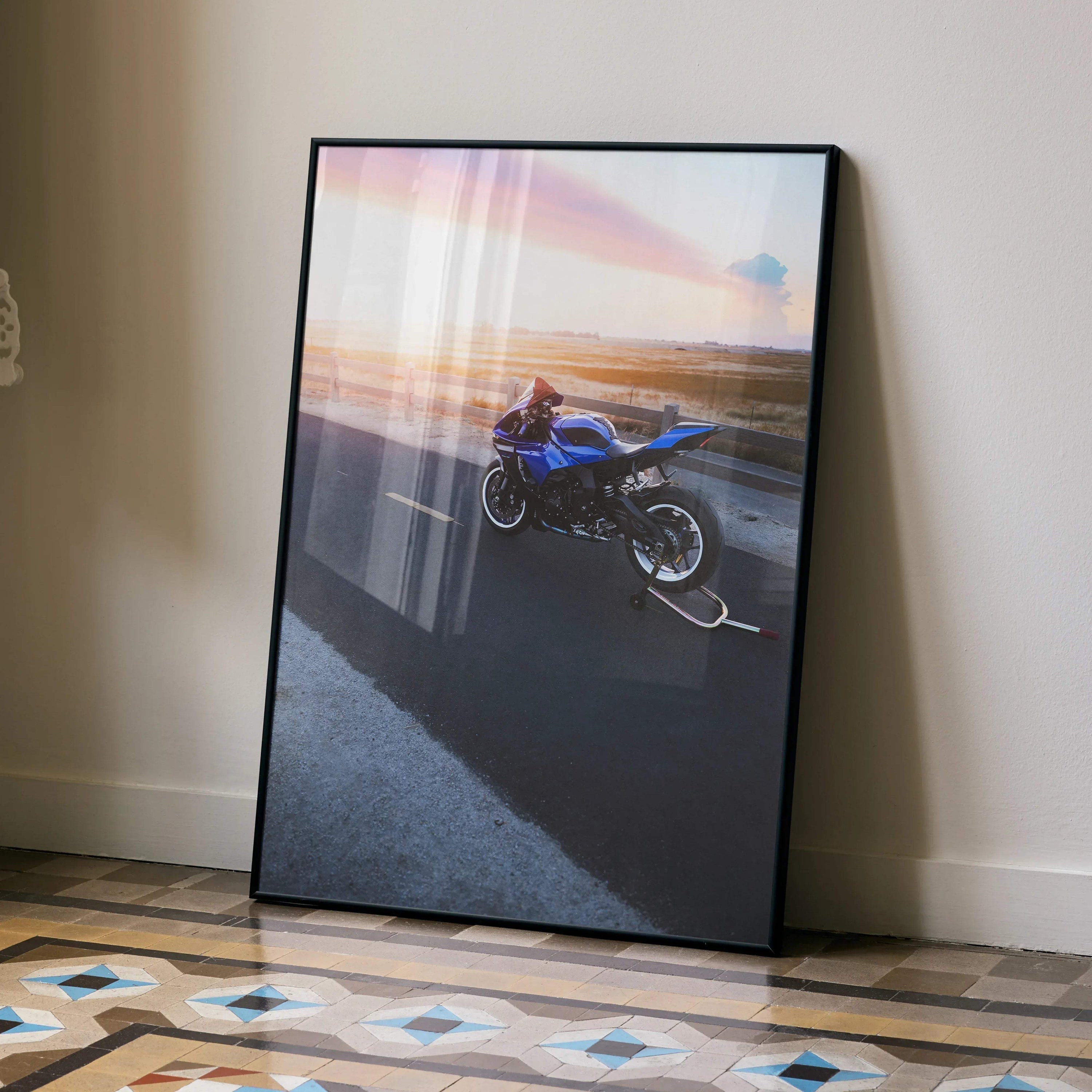 Yamaha YZF-R1 motorcycle poster with sunset background leaning against wall, sleek black frame wall art.