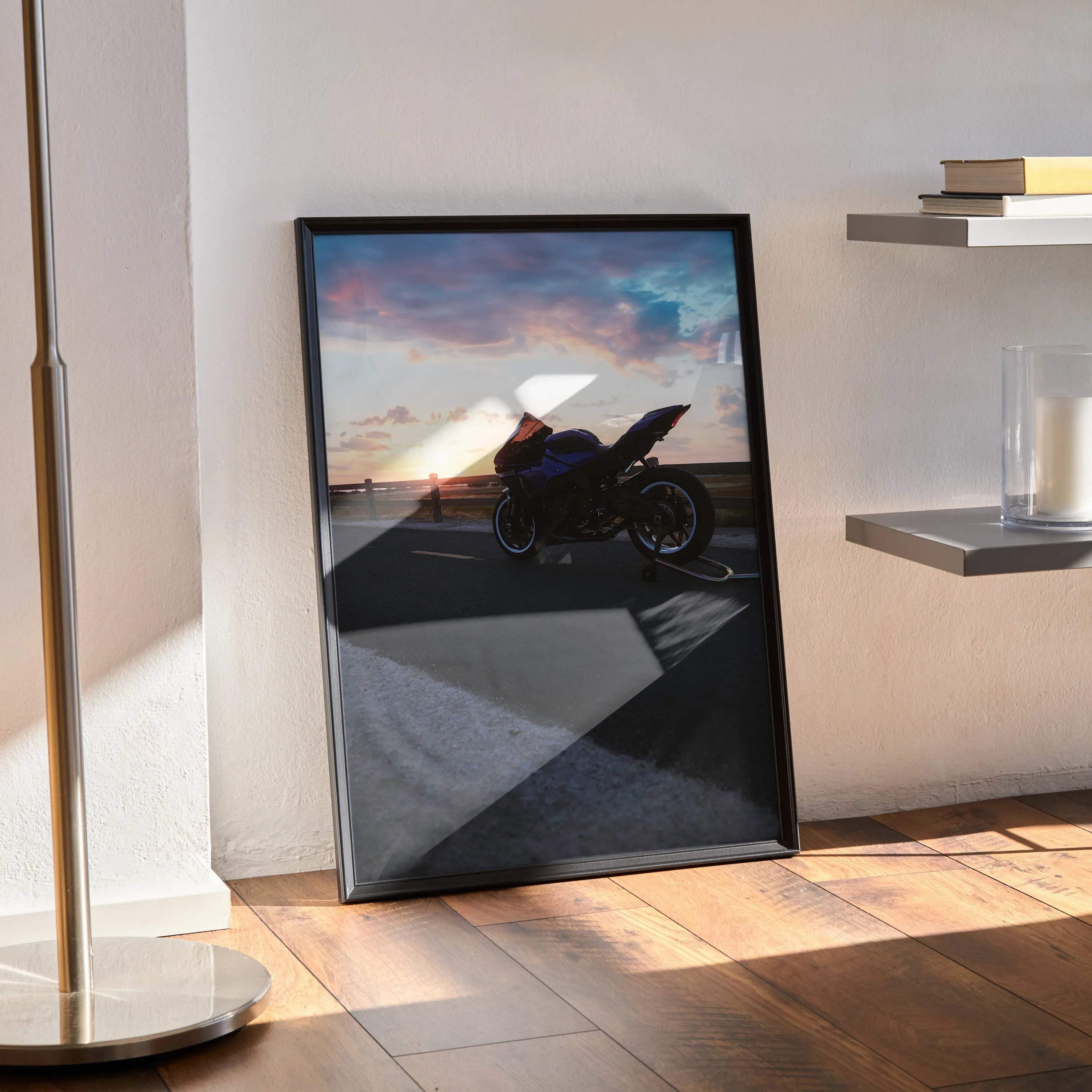 Yamaha R1 motorcycle poster with sunset backdrop leaning on floor as wall art.