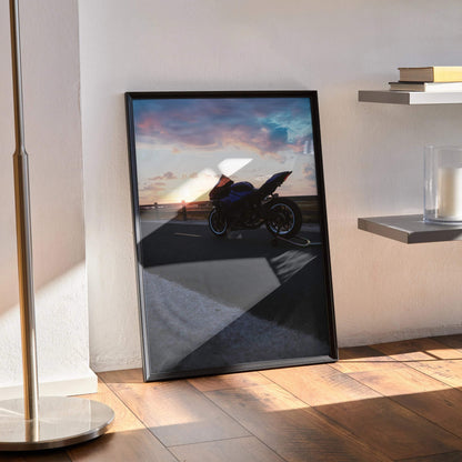 Yamaha R1 motorcycle poster with sunset backdrop leaning on floor as wall art.