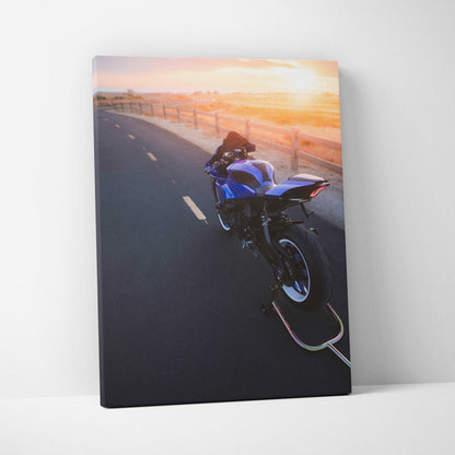 Blue Yamaha R1 motorcycle on open road at sunset canvas wall art in vertical format.